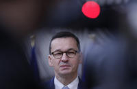 FILE - In this Oct. 2, 2020, file photo, Poland's Prime Minister Mateusz Morawiecki speaks on camera as he arrives for an EU summit at the European Council building in Brussels. The European Union still hasn't completely sorted out its messy post-divorce relationship with Britain — but it has already been plunged into another major crisis. This time the 27-member union is being tested as Poland and Hungary block passage of its budget for the next seven years and an ambitious package aimed at rescuing economies ravaged by the coronavirus pandemic. (Olivier Hoslet/Pool Photo via AP, File)