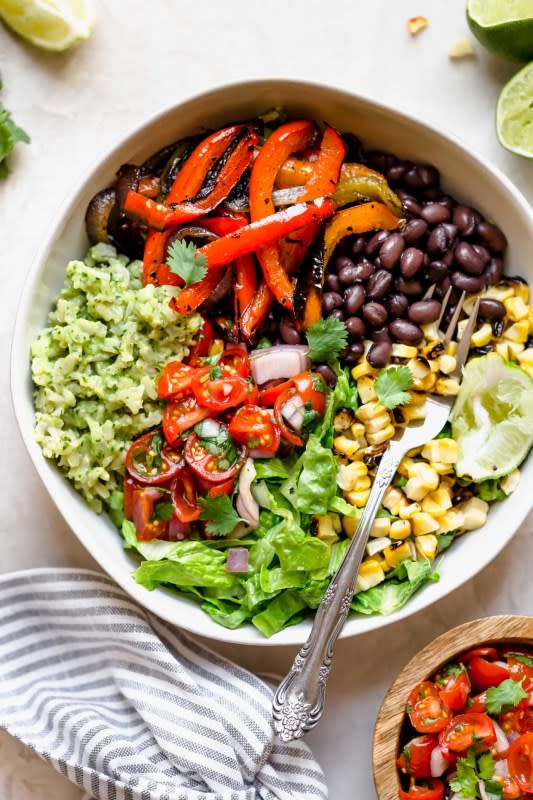 <p>Plays Well With Butter</p><p>Move over chipotle, these easy and healthy vegetarian black bean burrito bowls with green rice are loaded with flavor!</p><p><strong>Get the recipe: <a href="https://playswellwithbutter.com/grilled-veggie-burrito-bowls/" rel="nofollow noopener" target="_blank" data-ylk="slk:Grilled Veggie Burrito Bowls;elm:context_link;itc:0;sec:content-canvas" class="link ">Grilled Veggie Burrito Bowls</a></strong></p>