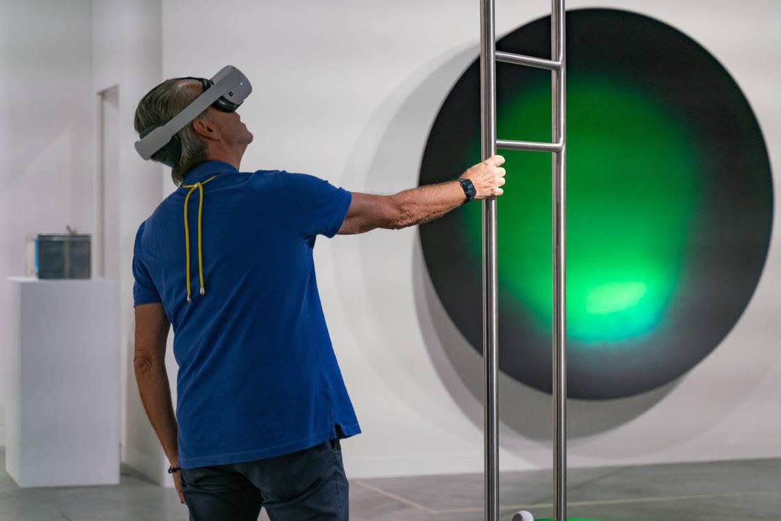 A person interacts with “Swimming Pool VR” by Leandro Erlich during Art Basel.