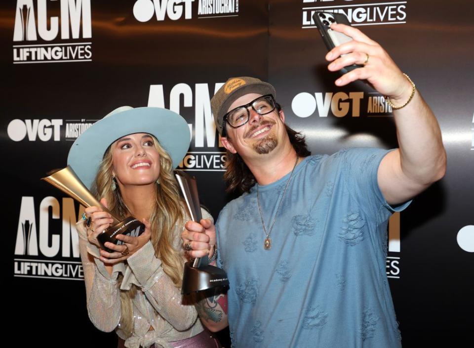 the colony, texas may 10 lainey wilson and hardy pose for a selfie with acm awards they were presented at a press conference after their performances at the 2023 acm lifting lives topgolf tee off and rock on fundraiser at topgolf on may 10, 2023 in the colony, texas photo by richard rodriguezgetty images