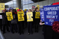 Hundreds of flight attendants protest at O'Hare International Airport in Chicago, Tuesday, Feb. 13, 2024. They represent three different unions and work for several airlines including Southwest, American, and United. Each of the unions are in contract negotiations with the airlines and pushing for fair contracts. (AP Photo/Nam Y. Huh)