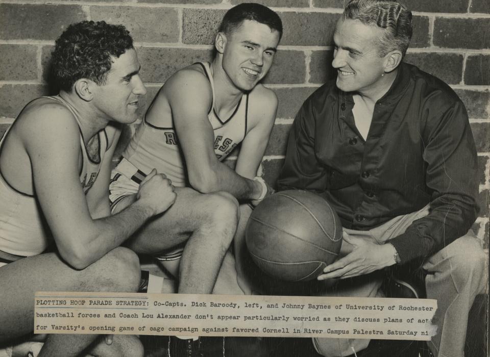 In 1946, months after returning home from service, Dick Baroody, left, and Johnny Baynes, middle, became co-captains of the basketball team, rejoining coach Lou Alexander. This photo was taken before the 1946-47 season opener against Cornell.