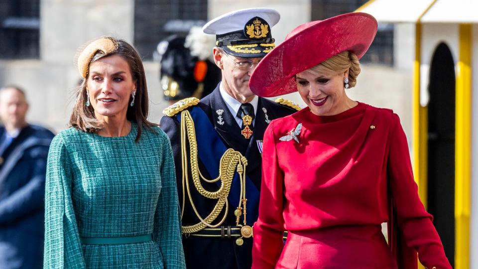 Queen Letizia in emerald green tweed walking with Queen Maxima