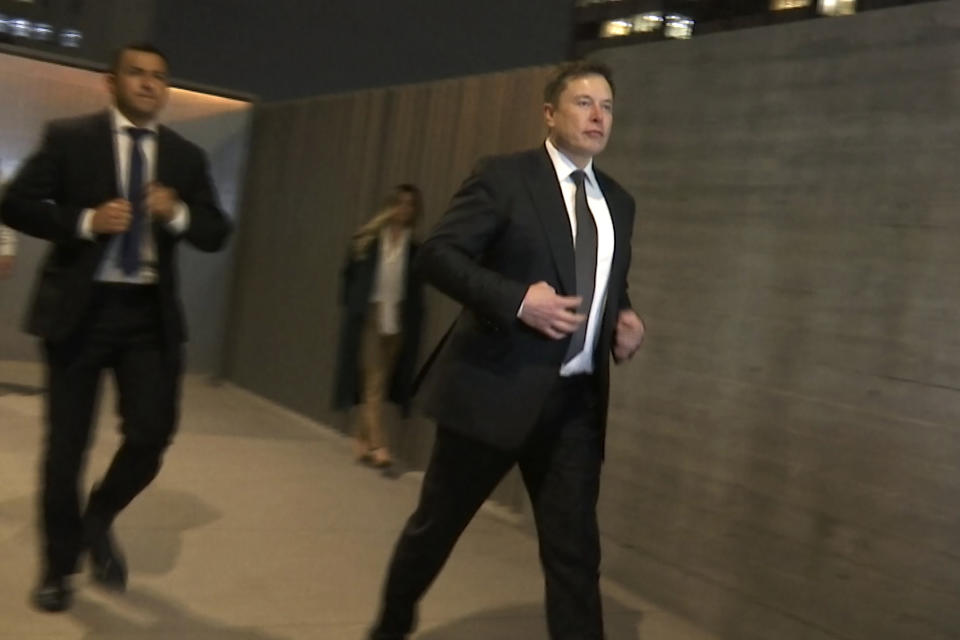 In this frame grab from video, Tesla CEO Elon Musk leaves court, Tuesday, Dec. 3, 2019, in Los Angeles. Musk denied that he meant to call a British cave diver a pedophile when he dubbed him "pedo guy" on social media. (AP Photo/Krysta Fauria)