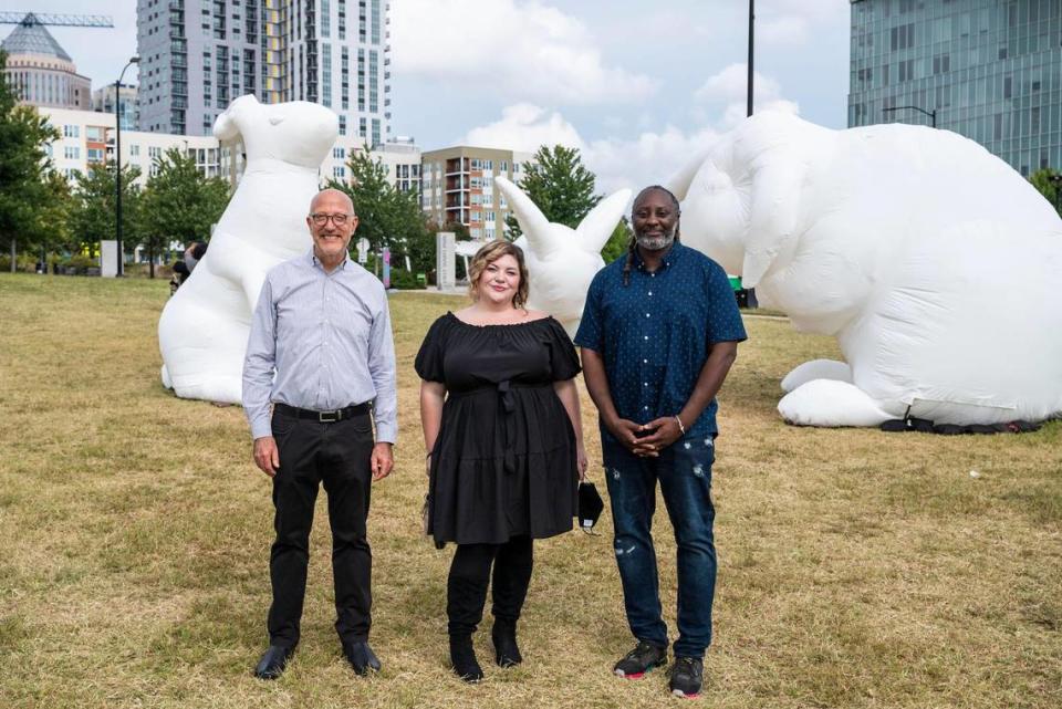 From left, Tom Gabbard, president of Blumenthal Performing Arts, Bree Stallings, director of artistic experience and Boris “Bluz” Rogers, director of creative engagement in front of inflatable rabbits of the installation, “Intrude” in First Ward Park. They also worked to bring the “Of Earth and Sky” to Charlotte.