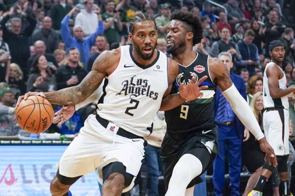 Los Angeles Clippers' Kawhi Leonard drives past Milwaukee Bucks' Wesley Matthews during the first half of an NBA basketball game Friday, Dec. 6, 2019, in Milwaukee. (AP Photo/Morry Gash)
