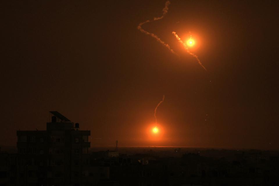 TOPSHOT - Flares fired by the Israeli army light up the sky east of Khan Yunis on the southern Gaza Strip on October 27, 2023 as battles between Israel and the Palestinian Hamas movement continue. (AFP via Getty Images)