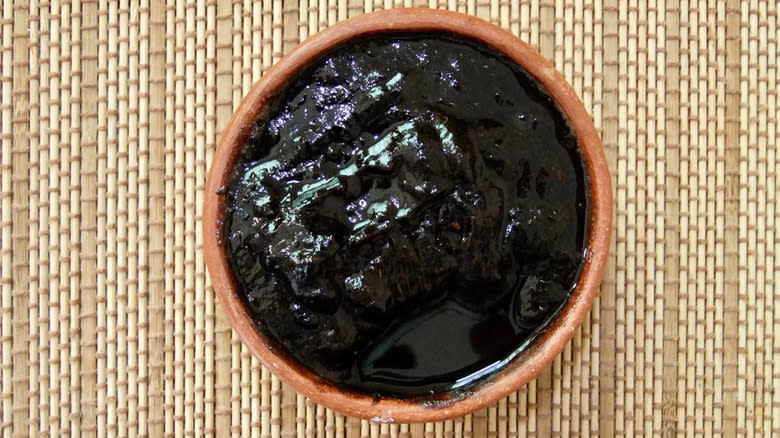 Black sapote in brown bowl