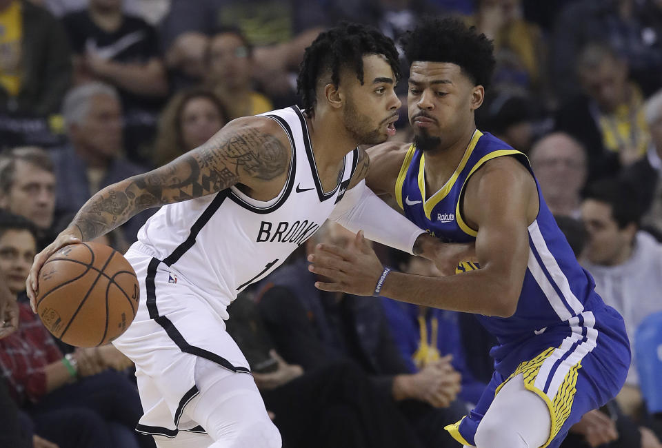 Brooklyn Nets guard D'Angelo Russell, left, drives against Golden State Warriors guard Quinn Cook during the first half of an NBA basketball game in Oakland, Calif., Saturday, Nov. 10, 2018. (AP Photo/Jeff Chiu)