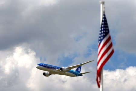 An Boeing 787-9 Dreamliner of Air Tahiti Nui flies past U.S. flag as it performs during the 53rd International Paris Air Show at Le Bourget Airport near Paris