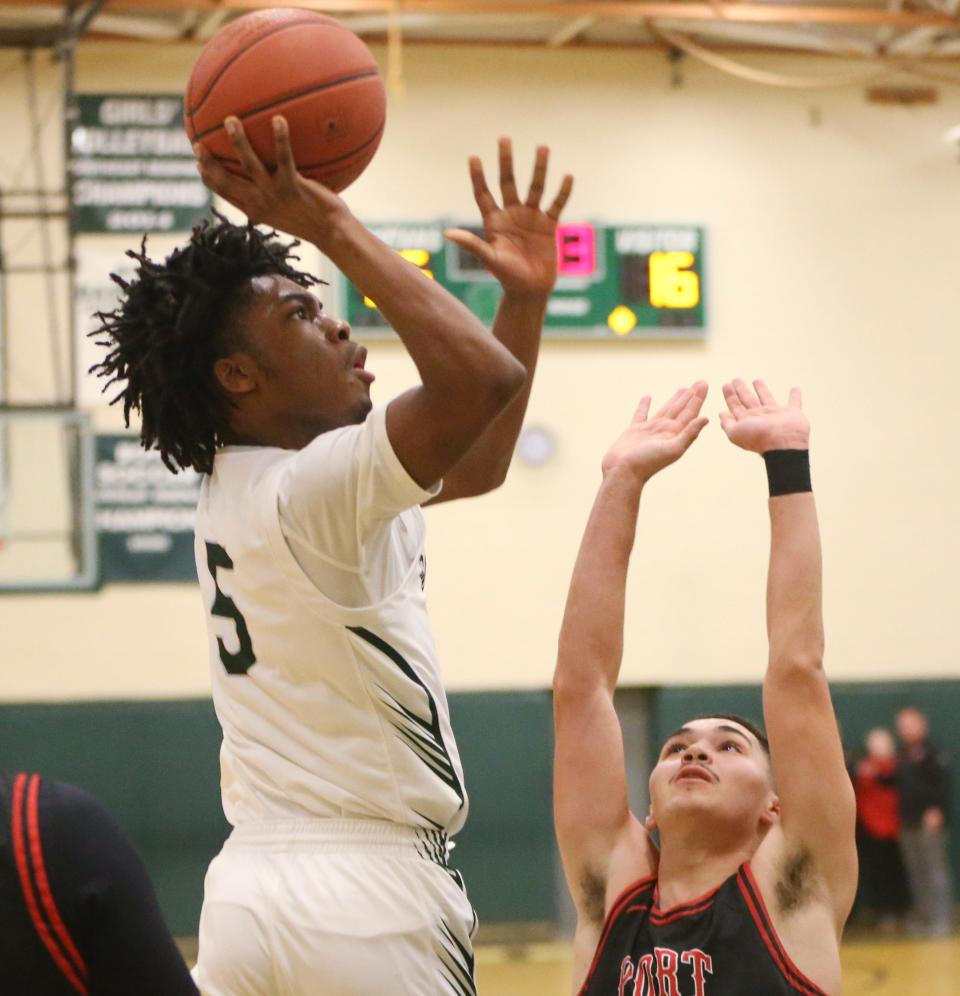 Spackenkill's Nasir Snell takes a shot over Port Jervis' Jaren Rodriguez during the Section 9 Class A boys basketball quarter final on February 26 2024.