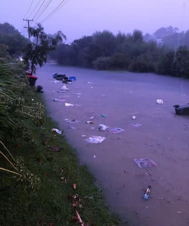 The overflowing river is seen in Auckland, New Zealand, February 1, 2018 in this picture obtained from social media. COURTESY of MARIPAZ ADONIS /via REUTERS