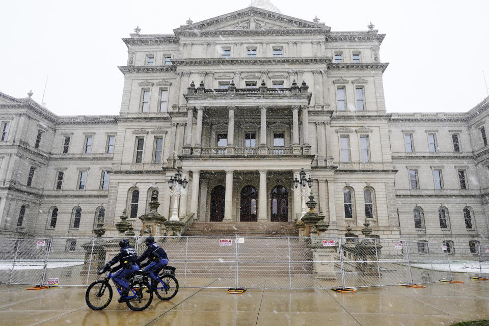 Michigan State Police officers patrol outside the state Capitol in Lansing, Mich., Friday, Jan. 15, 2021. / Credit: Carlos Osorio / AP