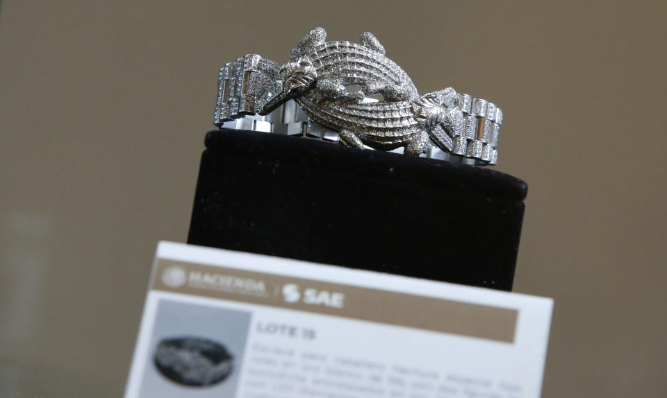 A men's bracelet made of 18K white gold and featuring two crocodiles entwined and covered with 1,331 diamonds is displayed to the public during an auction of government seized jewelry at Los Pinos Cultural Center, formerly the presidential residence, in Mexico City, Sunday, July 28, 2019. (AP Photo/Ginnette Riquelme)