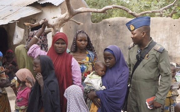 A soldier from the Nigerian army talks with hostage women and children who were freed from Boko Haram, in Yola, in this April 29, 2015 handout - HANDOUT/REUTERS