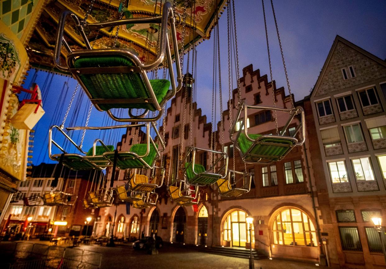 A chain carousel is seen in front of the town hall in Frankfurt, Germany on Wednesday, Oct. 7, 2020. The carousel is part of the "autumn market" which should open on Thursday but the opening will be delayed due to the new restrictions to avoid the further outspread of the Coronavirus.