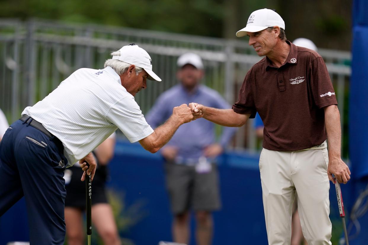 Fred Couples fist bumps Steven Alker, of New Zealand, right, after making his putt on the 18th green during the second round of the PGA Tour Champions Principal Charity Classic golf tournament, Saturday, June 4, 2022, in Des Moines, Iowa. (AP Photo/Charlie Neibergall)