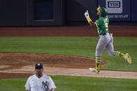Oakland Athletics' Tony Kemp runs the bases after hitting a three-run home run off New York Yankees relief pitcher Wandy Peralta, left, during the sixth inning of a baseball game Friday, June 18, 2021, in New York. (AP Photo/Frank Franklin II)