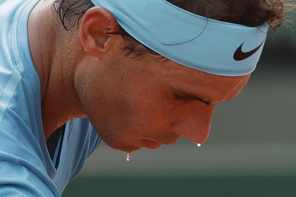 FILE - Beads of sweat run from Spain's Rafael Nadal's face as he prepares to serve against Austria's Dominic Thiem in the men's final match of the French Open tennis tournament at Roland Garros stadium in Paris, France, Sunday, June 10, 2018. (AP Photo/Alessandra Tarantino, File)