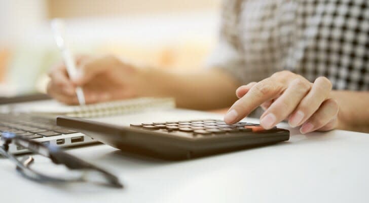 Image shows a person reviewing their finances. Fidelity Investments plans to launch a new product next year that will allow individuals to shift a portion of their employer-sponsored retirement plan into an annuity.