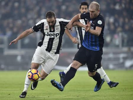 Football Soccer - Juventus v Atalanta - Italian Serie A - Juventus stadium, Turin, Italy - 3/12/16 - Juventus' Gonzalo Higuain in action with Atalanta's Andrea Masiello . REUTERS/Giorgio Perottino