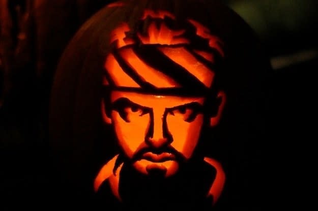 a portrait of a man carved on a pumpkin