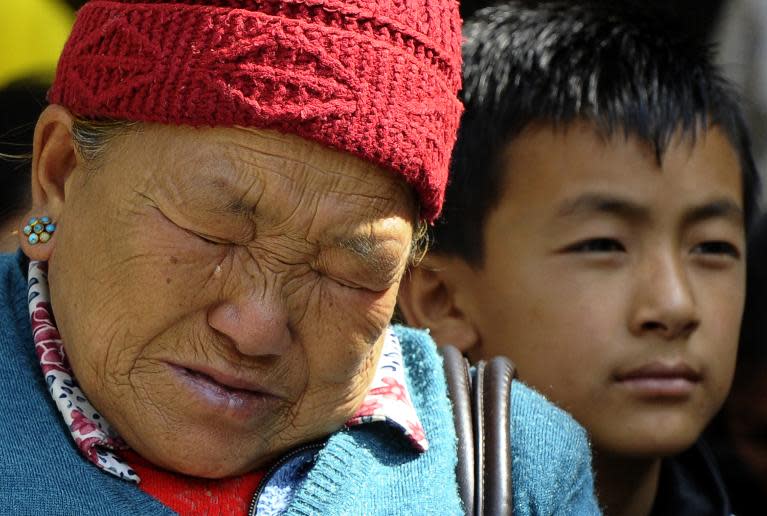 The mother of Mount Everest avalanche victim Ang Kazi Sherpa weeps as she waits for the body of her son to arrive at Sherpa Monastery in Kathmandu, on April 19, 2014
