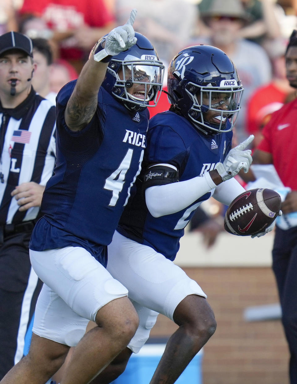 Rice cornerback Tre'shon Devones, right, celebrates his interception with safety Plae Wyatt during the first half of an NCAA college football game against Houston, Saturday, Sept. 9, 2023, in Houston. (AP Photo/Eric Christian Smith)