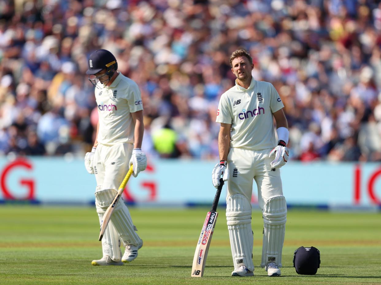 England batsman Dan Lawrence walks off after being dismissed for 0 as captain Joe Root looks on (Getty)