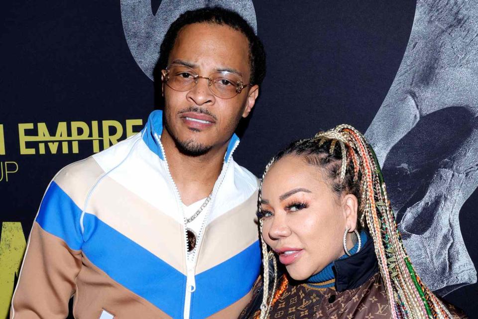 <p>Arnold Turner/Getty Images for Hidden Empire Film Group</p> T.I. and Tiny Harris attend a movie premiere in January 2023 in Los Angeles.