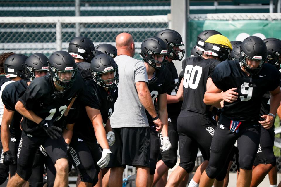 Sheldon football players break from a huddle during practice Wednesday, Aug. 23, 2023, at Sheldon High School in Eugene.