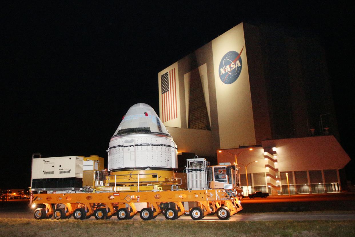 A Boeing CST-100 Starliner spacecraft is rolled out April 16 from a Boeing's facility past NASA's Kennedy Space Center in Cape Canaveral, Fla. A scheduled Monday launch to the International Space Station was delayed until at least Friday.