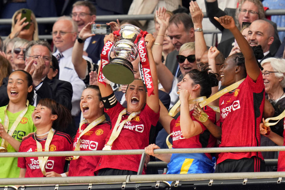 Manchester United's Katie Zelem lifted the trophy after winning the Women's FA Cup final soccer match between Manchester United and Tottenham Hotspur at Wembley Stadium in London, Sunday, May 12, 2024. Manchester United won 4-0. (AP Photo/Kirsty Wigglesworth)