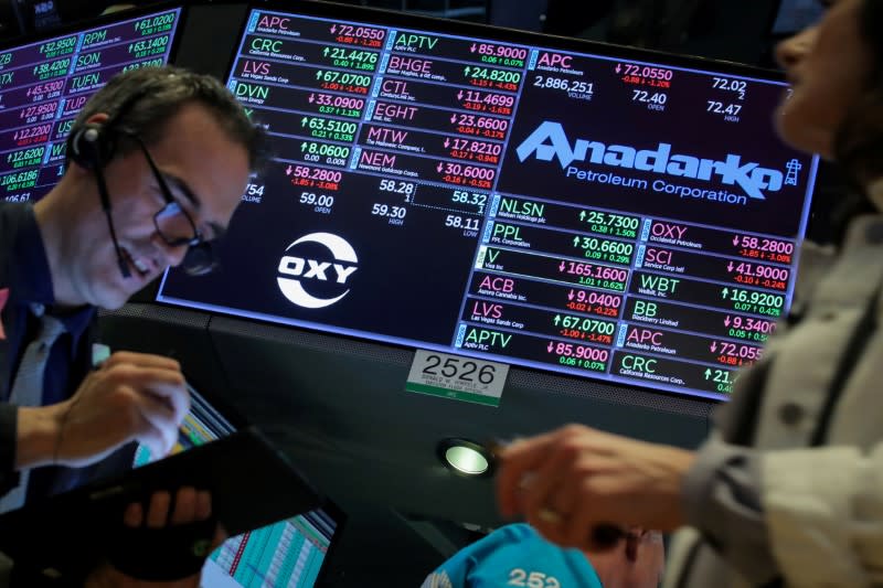 FILE PHOTO: Traders work on the floor by the post that trades Anadarko Petroleum and Occidental Petroleum at the NYSE in New York