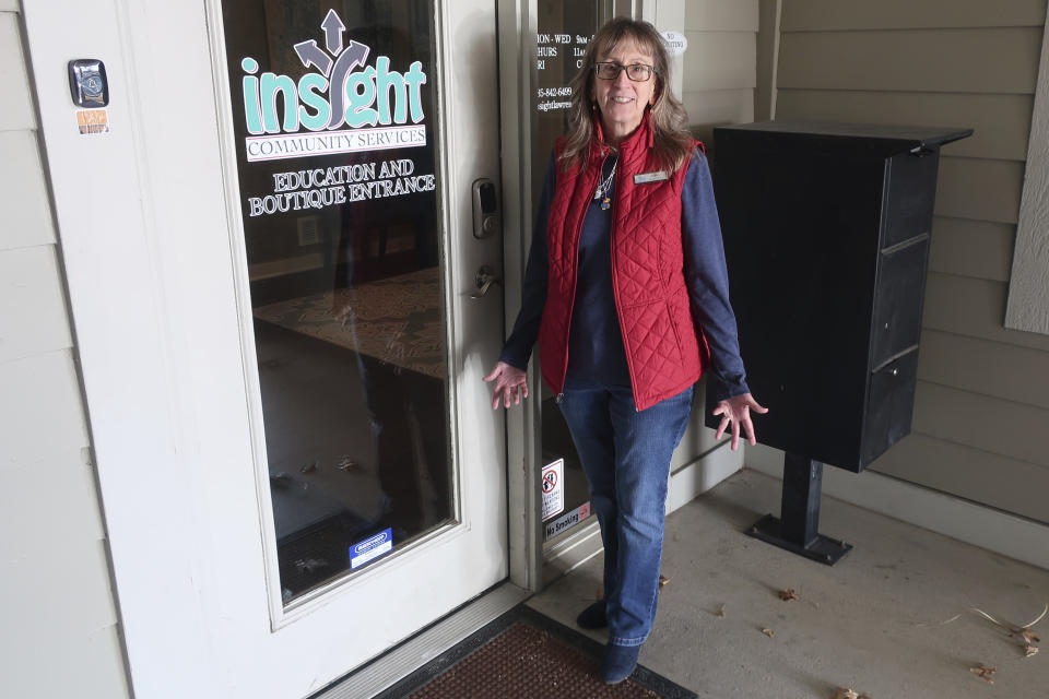 Bridgit Smith, executive director of the Insight Women's Center stands outside the door to its educational and Boutique with clothes and other supplies for new parents, Tuesday, Jan. 31, 2023, in Lawrence, Kansas. The biggest goal in the Kansas Legislature this year for abortion opponents is to provide financial aid to centers like Insight, which provide free services to encourage women to carry their pregnancies to term rather than get abortions. (AP Photo/John Hanna)