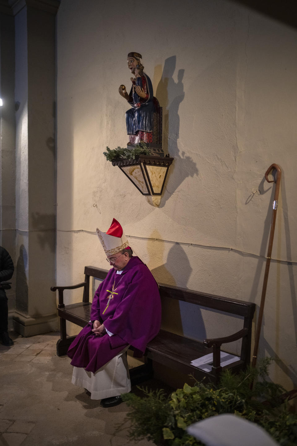 Local bishop Francesc Conesa sits next to the virgin Our Lady of the Torrents as he leads a mass in l'Espunyola, north of Barcelona, Spain, Sunday, March 26, 2023. Farmers and parishioners gathered Sunday at the small hermitage of l'Espunyola, a rural village in Catalonia, to attend a mass asking the local virgin Our Lady of the Torrents for rain. The eastern Spanish region is among the worst affected by the severe drought that hits the whole of the Mediterranean country. (AP Photo/Emilio Morenatti)