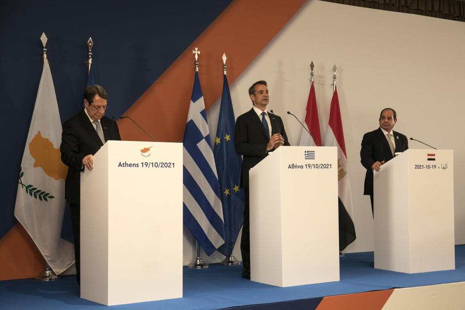 Greece's Prime Minister Kyriakos MItsotakis, center, Cyprus' President Nicos Anastasiades, left, and Egypt's President Abdel Fattah al-Sisi make statements following a meeting in Athens, Greece, Tuesday, Oct. 19, 2021. Athens hosts the 9th trilateral meeting between the three countries. (AP Photo/Yorgos Karahalis)