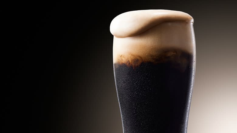 stout beer overflowing glass