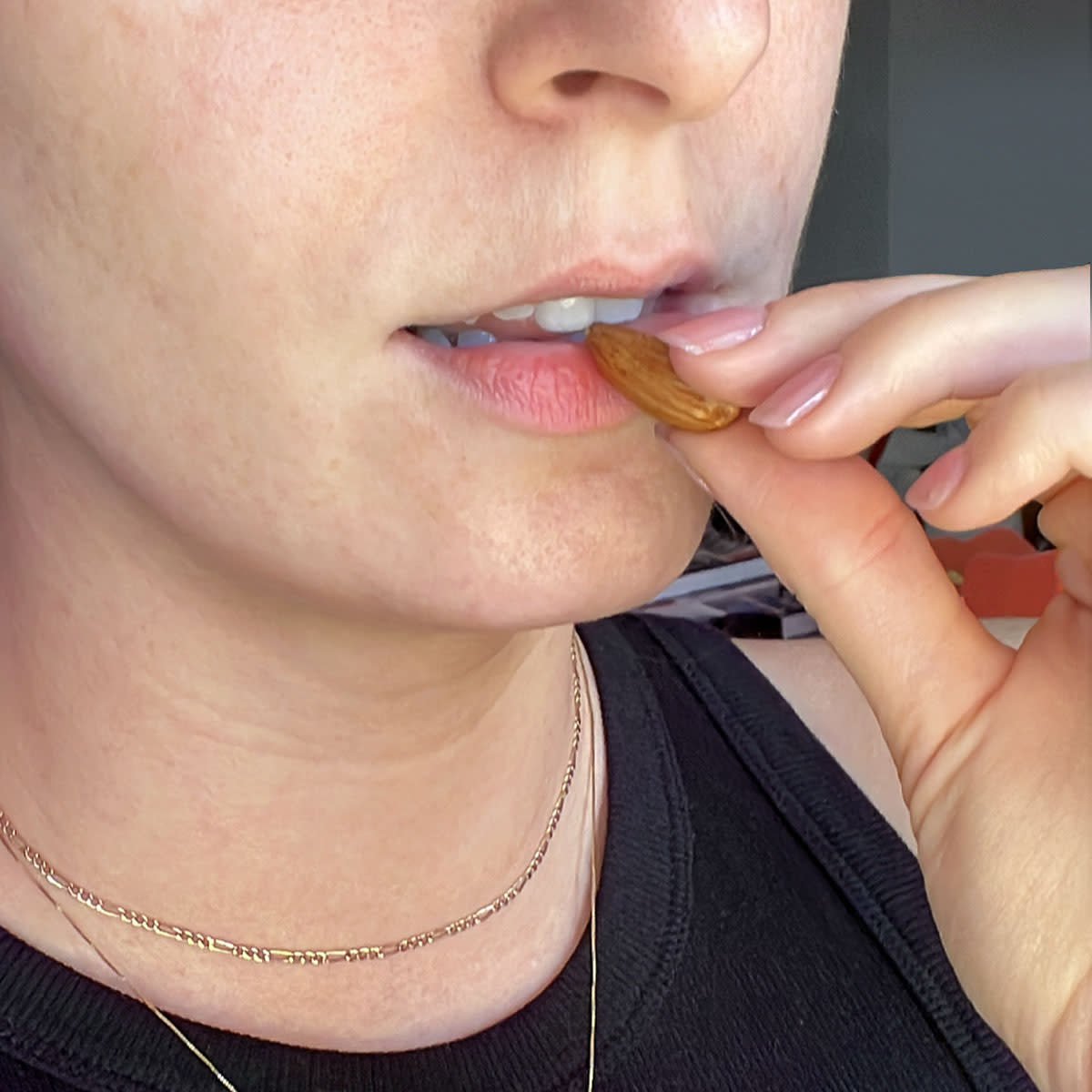 Woman biting into an almond