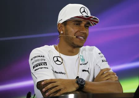 Mercedes Formula One driver Lewis Hamilton of Britain smiles during a news conference at the Yas Marina circuit before the start of the Abu Dhabi Grand Prix November 20, 2014. REUTERS/Ahmed Jadallah