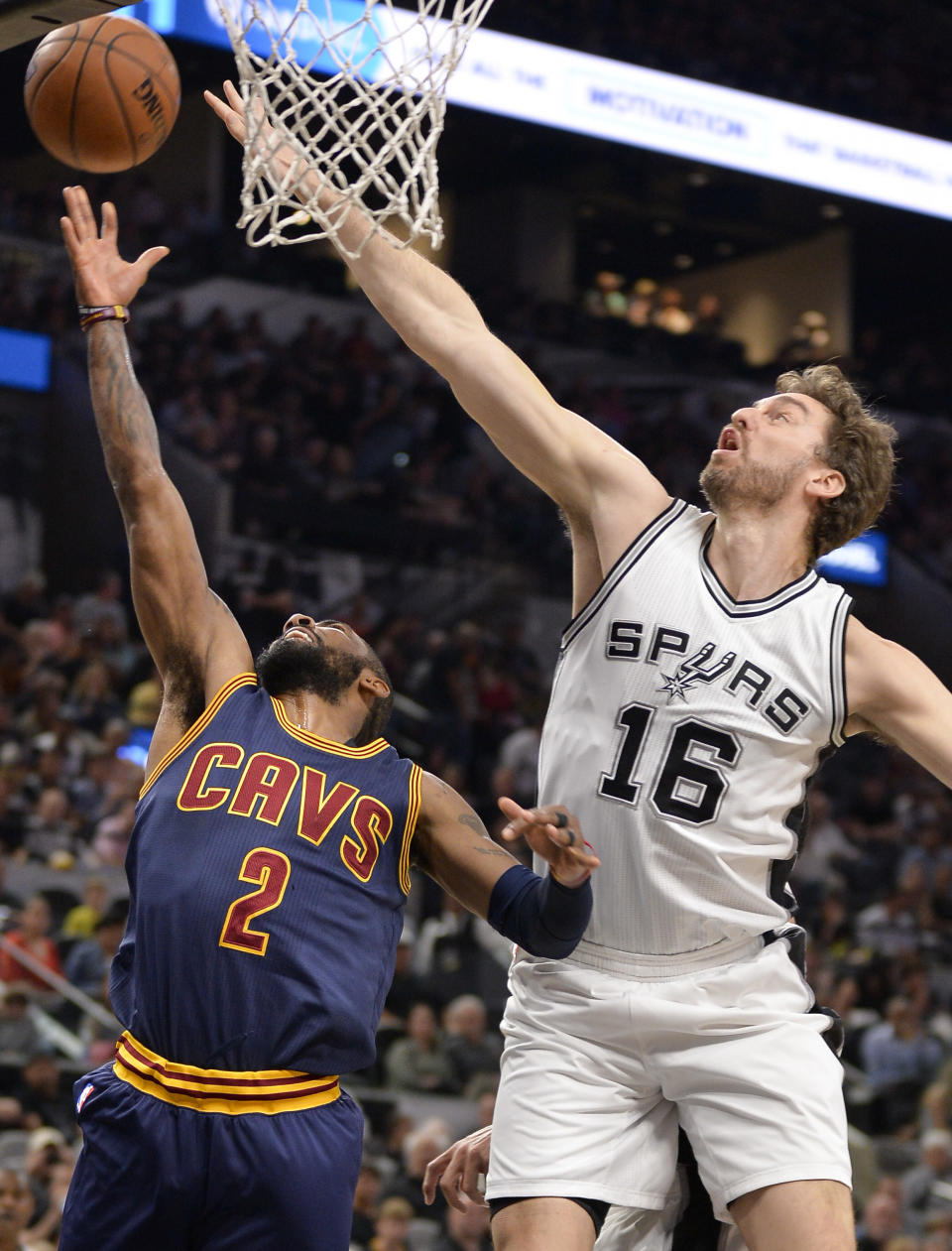 Cleveland Cavaliers guard Kyrie Irving (2) shoots against San Antonio Spurs center Pau Gasol, of Spain, during the first half of an NBA basketball game, Monday, March 27, 2017, in San Antonio. (AP Photo/Darren Abate)