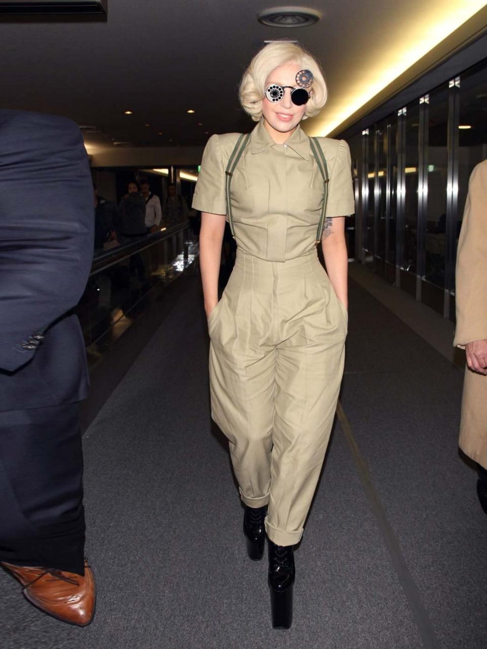 <p>Lady Gaga arrives in Japan to promote her new album <em>Artpop </em>in a khaki jumpsuit, November 2013.</p>