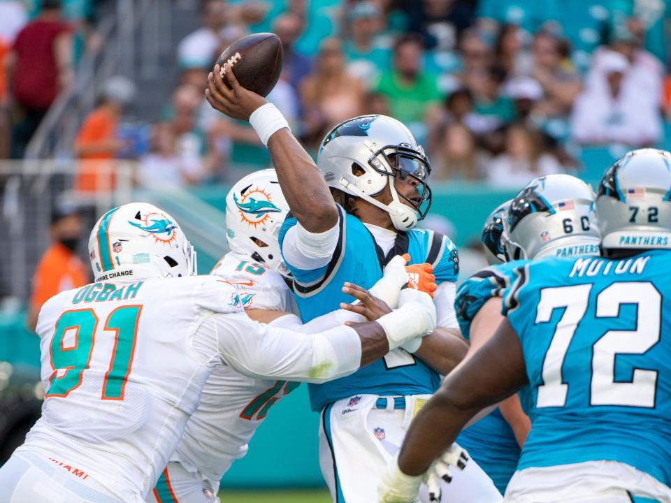Cam Newton is brought down by the Miami Dolphins defense.