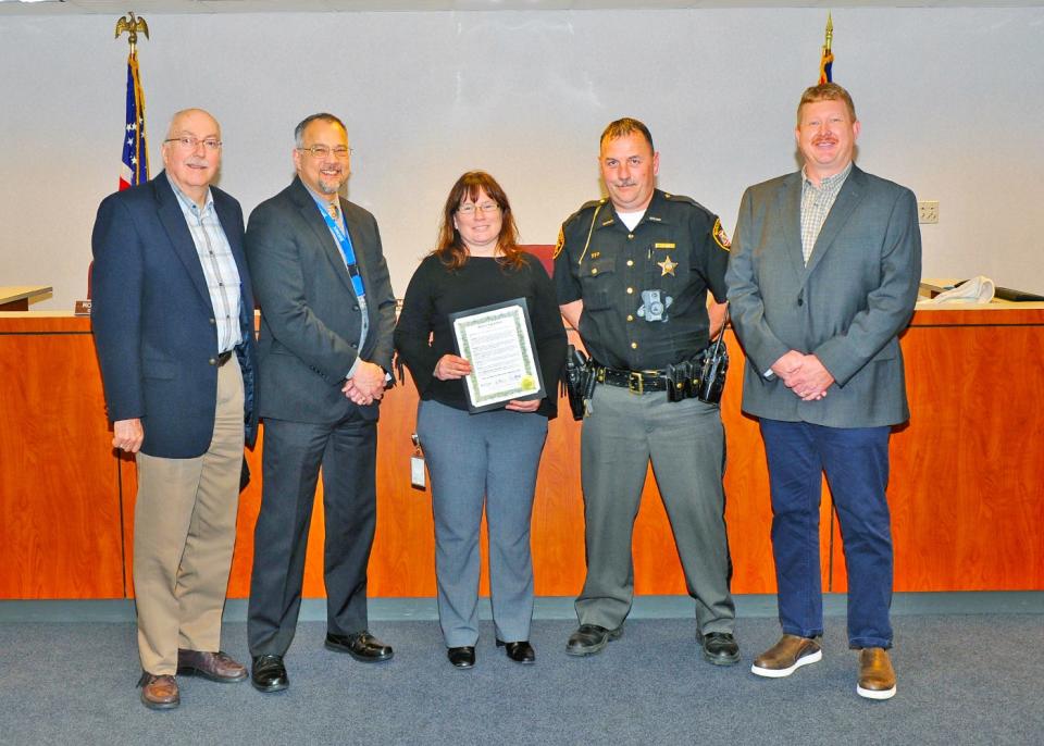 Wayne County Commissioner Ron Amstutz, left to right, Job and Family Services Director Rich Owens, Sherry Vitallo, benefit recovery supervisor, Tom Holmes, Wayne County Sheriff's Office deputy and Commissioner Jonathan Hofstetter pose for a photo after commissioners issue a proclamation naming May Public Assistance Fraud Awareness Month.
