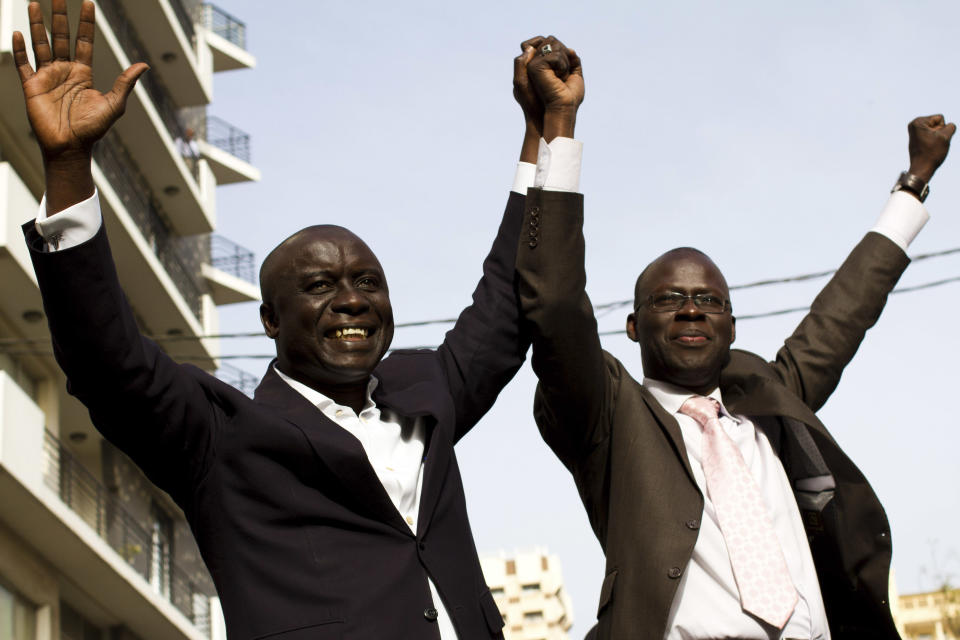 Opposition presidential candidates Idrissa Seck, left, and Cheikh Bamba Dieye raise their hands in a show of unity at an unauthorized anti-government protest in central Dakar, Senegal, Wednesday, Feb. 22, 2012. Thousands of supporters turned out to see Senegalese President Abdoulaye Wade Wednesday as he held rallies in the downtrodden Pikine and Guediawaye suburbs. Daily protests have rocked the capital after the opposition vowed to render the country ungovernable if 85-year-old Wade runs for a third term in Sunday's elections.(AP Photo/Tanya Bindra)