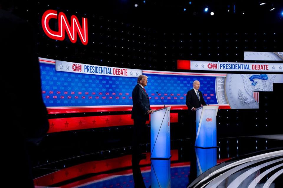 Donald Trump and Joe Biden standing behind podiums in a CNN studio.
