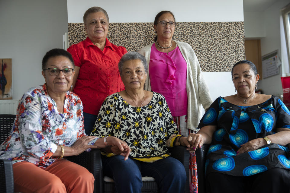 In this photo taken on Monday, June 29, 2020, clockwise from top left, Simone Ngalula, Monique Bitu Bingi, Lea Tavares Mujinga, Noelle Verbeeken and Marie-Jose Loshi pose for a group photo during an interview with The Associated Press in Brussels. Five women who were taken from their families as children in Belgian Congo and placed in a religious mission run by Catholic nuns have filed a lawsuit seeking reparations from Belgium. The women were among thousands of biracial children seized from their mothers and separated from their African roots by Belgian authorities ruling over the area from 1908-1960. (AP Photo/Francisco Seco)