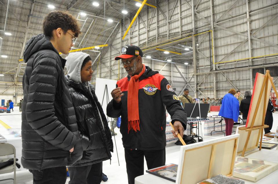 From right, Don Blakey from the John H. Porter Chapter of the Tuskegee Airmen talks with Greg Pitts and Jack Ferrell from Freire Charter School in Wilmington about Delawareans involved with the Tuskegee Airmen at the inaugural Tuskegee Airmen Commemoration Day in Dover March 28.