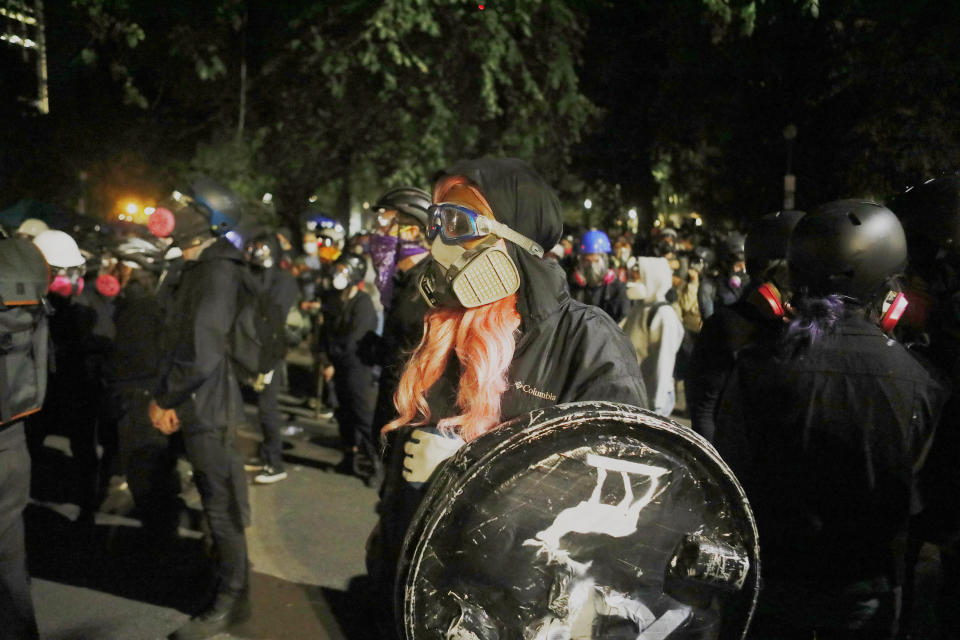 Daria Allen, de 16 años, con un equipo de protección que cubre todo menos su distintiva peluca brillante, en una de las manifestaciones nocturnas en Portland, Oregon, el 25 de julio de 2020. (Octavio Jones/The New York Times)