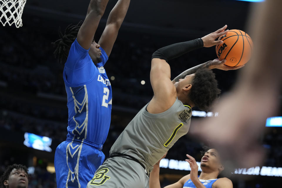 Creighton forward Arthur Kaluma, top left, goes up to block a shot by Baylor guard Keyonte George in the first half of a second-round college basketball game in the men's NCAA Tournament, Sunday, March 19, 2023, in Denver. (AP Photo/David Zalubowski)